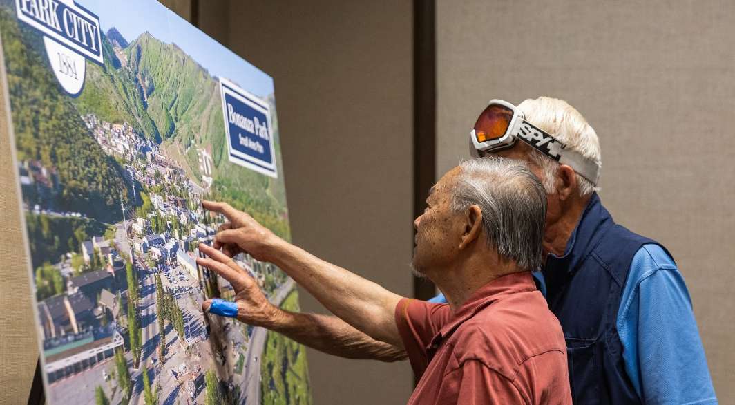 5-Acre Site Open House two people pointing at rendering